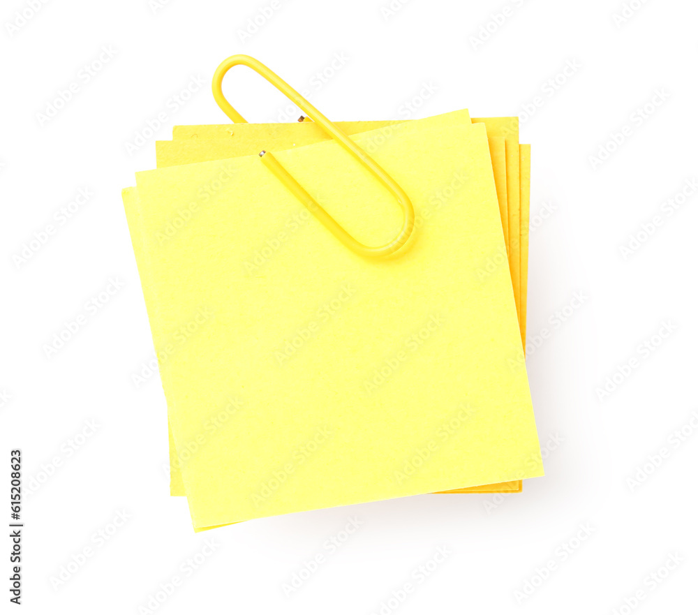 Yellow sticky note with paper clip on white background