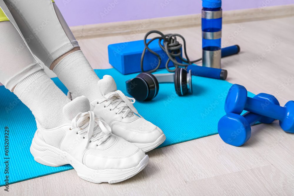 Woman with sports equipment in gym, closeup