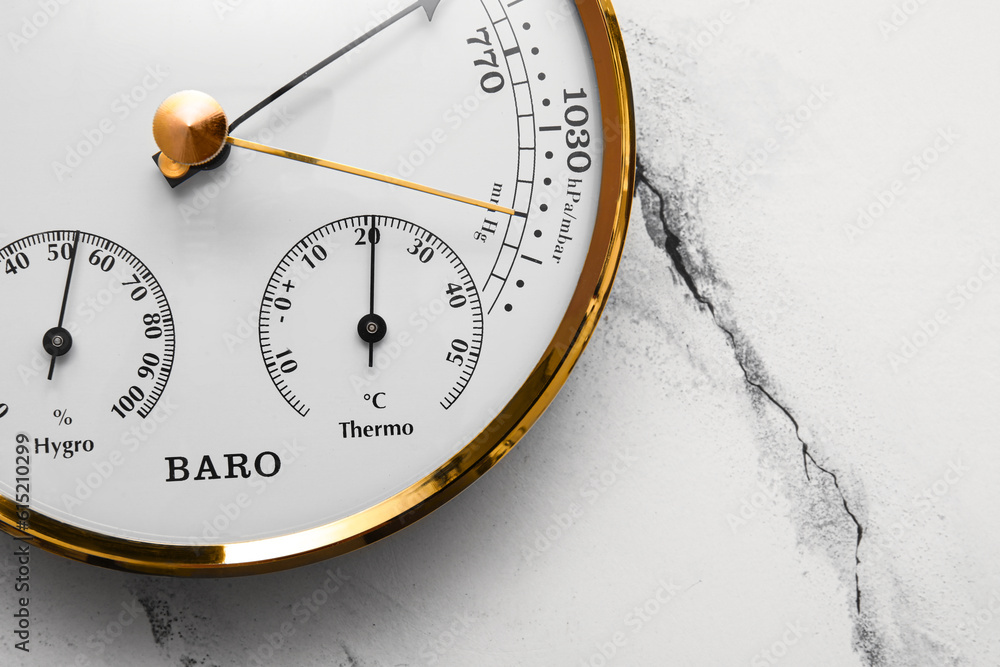 Aneroid barometer on white marble background