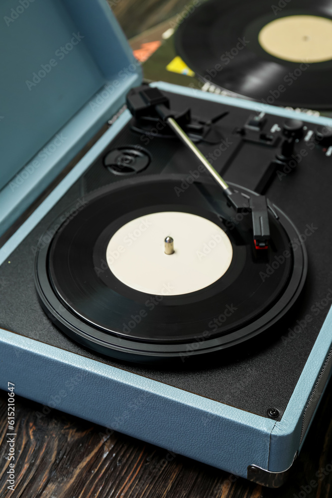 Record player with vinyl disk on dark wooden background, closeup