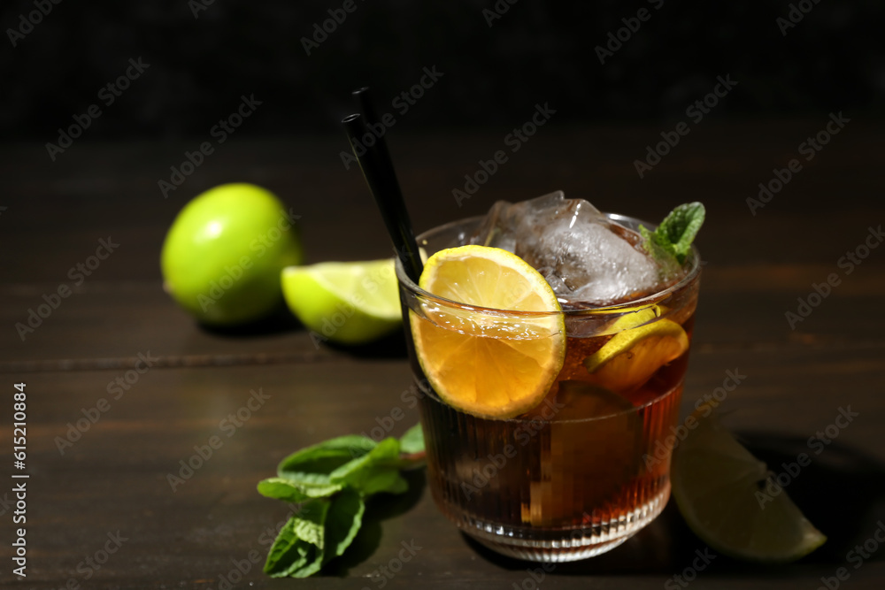 Glass of tasty Cuba Libre cocktail on table