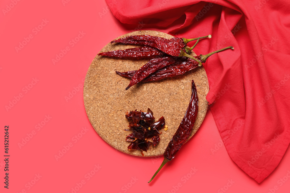 Composition with dry hot chili peppers on red background