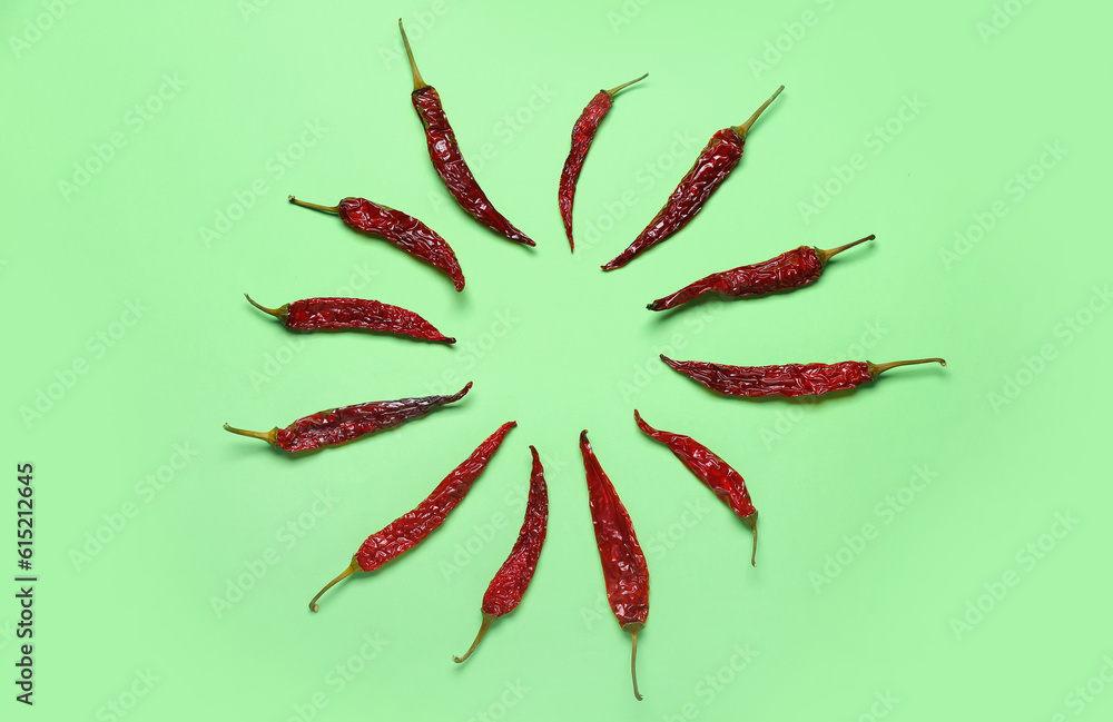 Frame made of dry chili peppers on pale green background