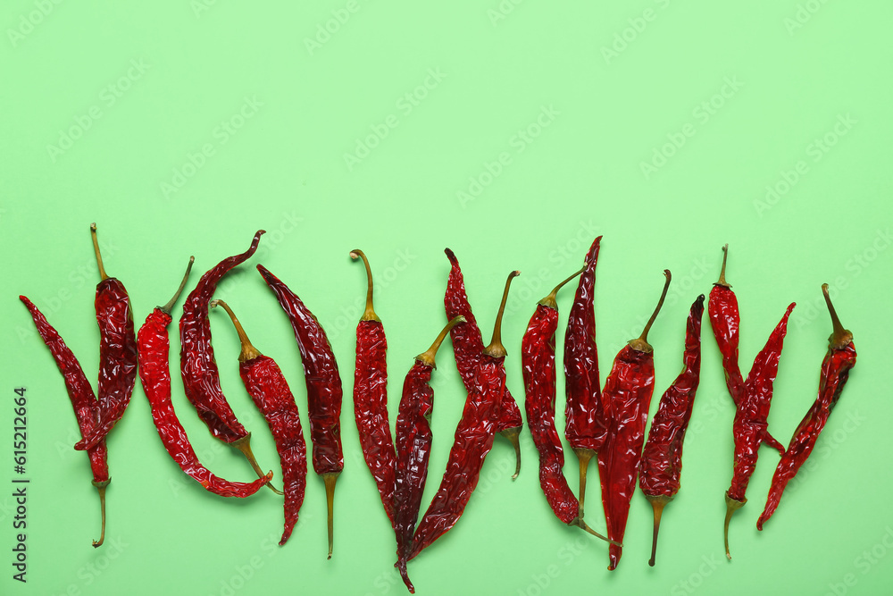 Dry hot chili peppers on pale green background