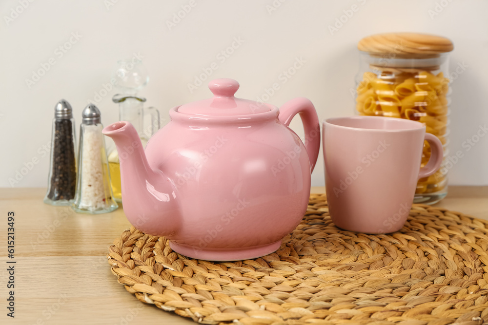 Composition with beautiful tea set and different kitchen stuff on wooden table