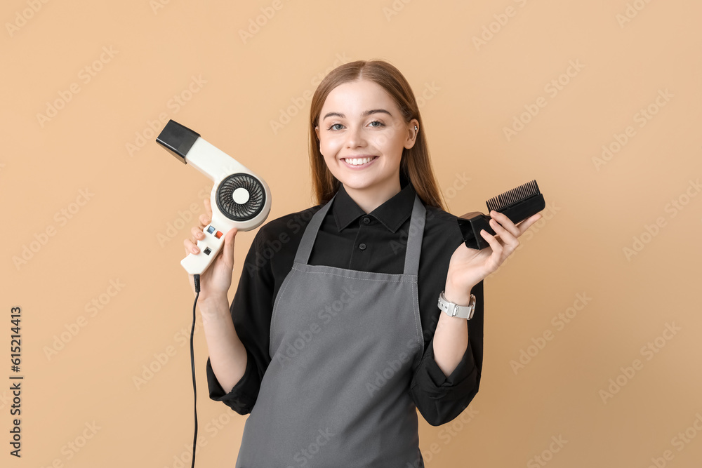 Female hairdresser with dryer on beige background