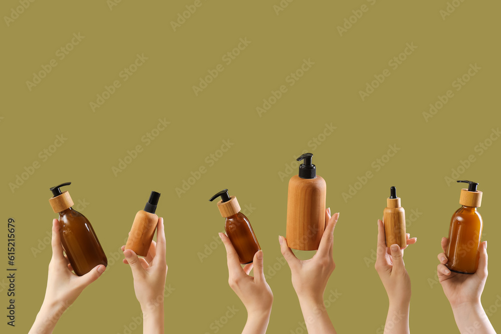 Hands holding different cosmetic products on color background