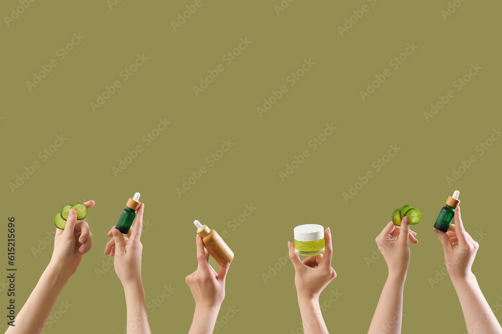 Hands holding different cosmetic products on color background