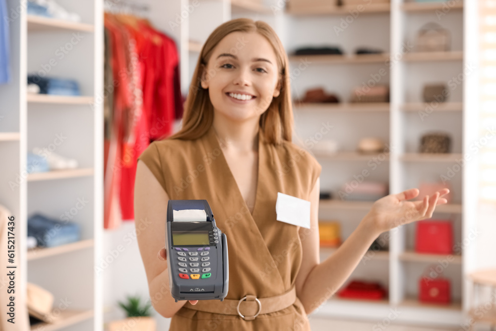 Female seller with payment terminal in boutique