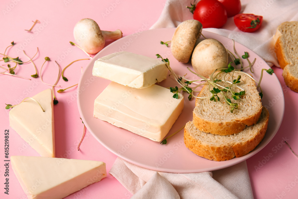 Plate with processed cheese, bread, mushrooms and microgreens on pink background