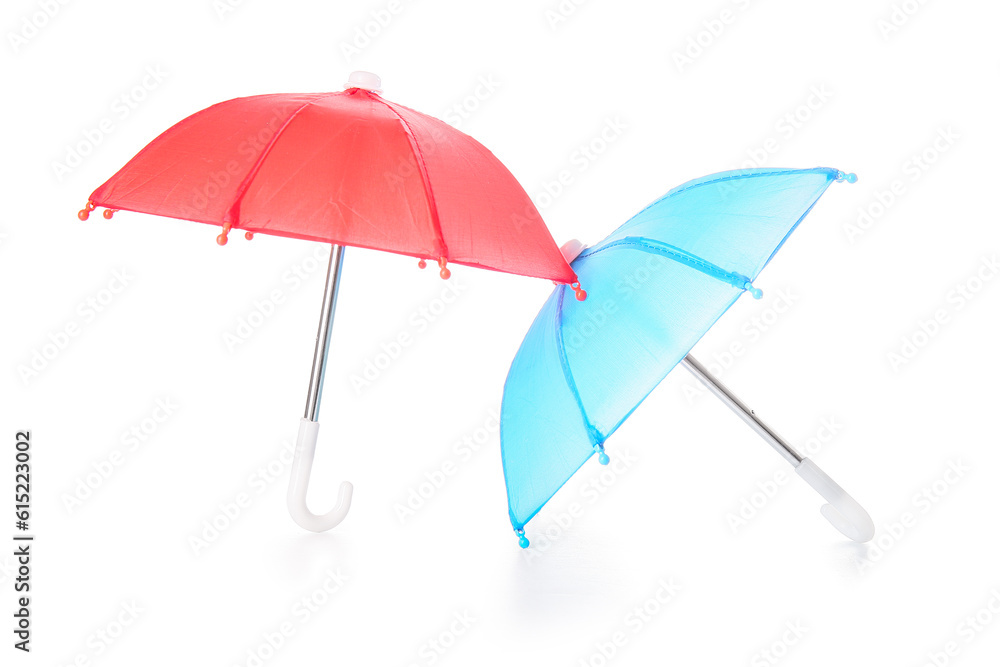 Different mini umbrellas on white background