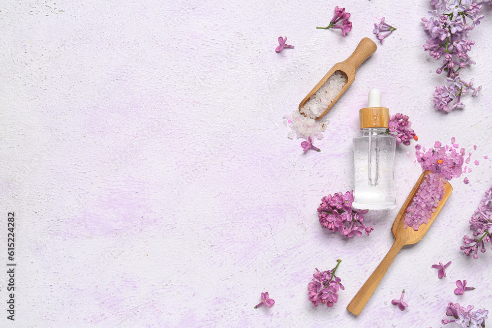 Composition with bottle of lilac essential oil, spoons with sea salt and flowers on light background