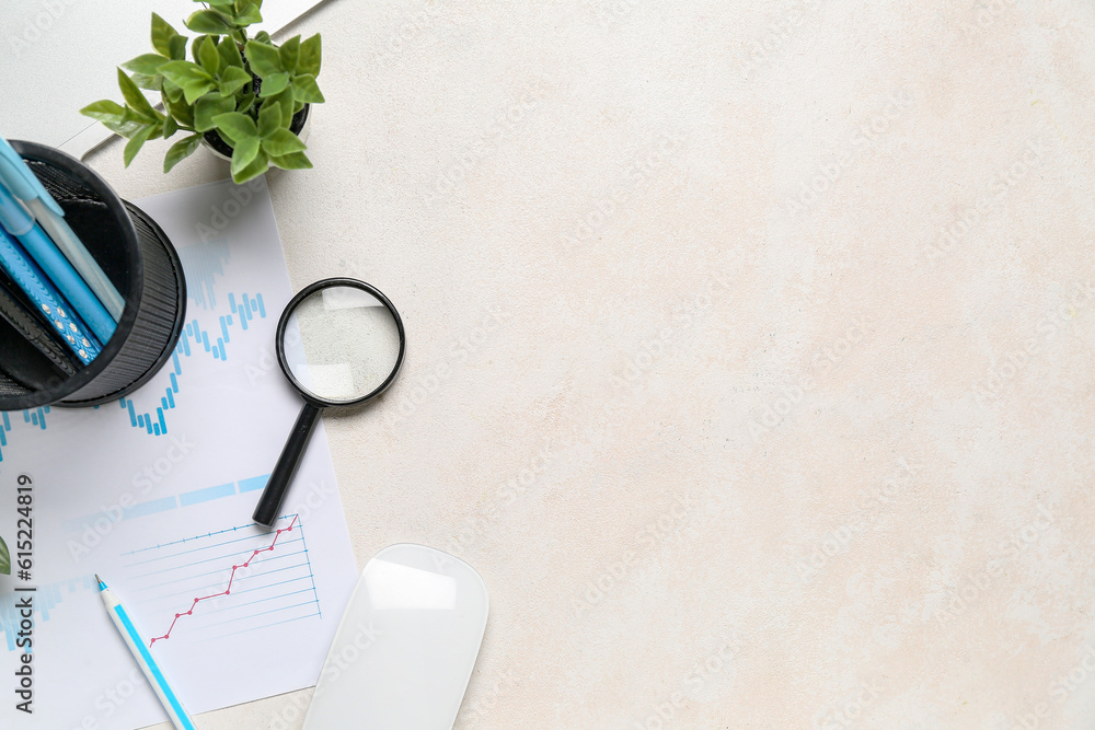 Magnifier with business charts on white table in office