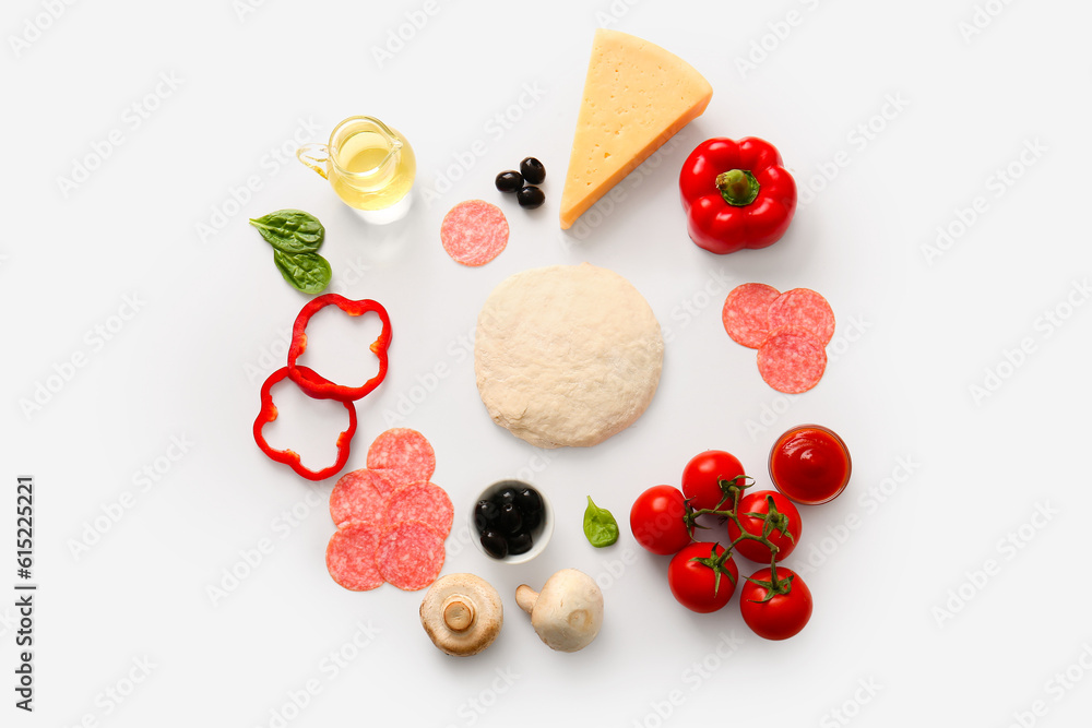 Raw dough and ingredients for preparing pizza on white background