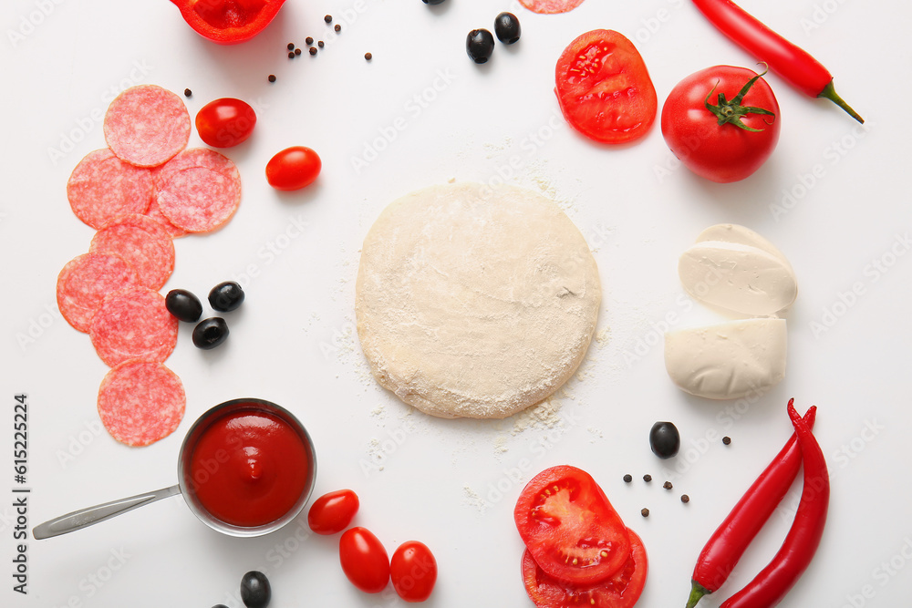 Raw dough and ingredients for preparing pizza on white background