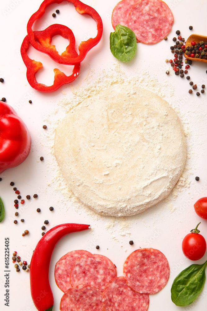 Raw dough and ingredients for preparing pizza on white background