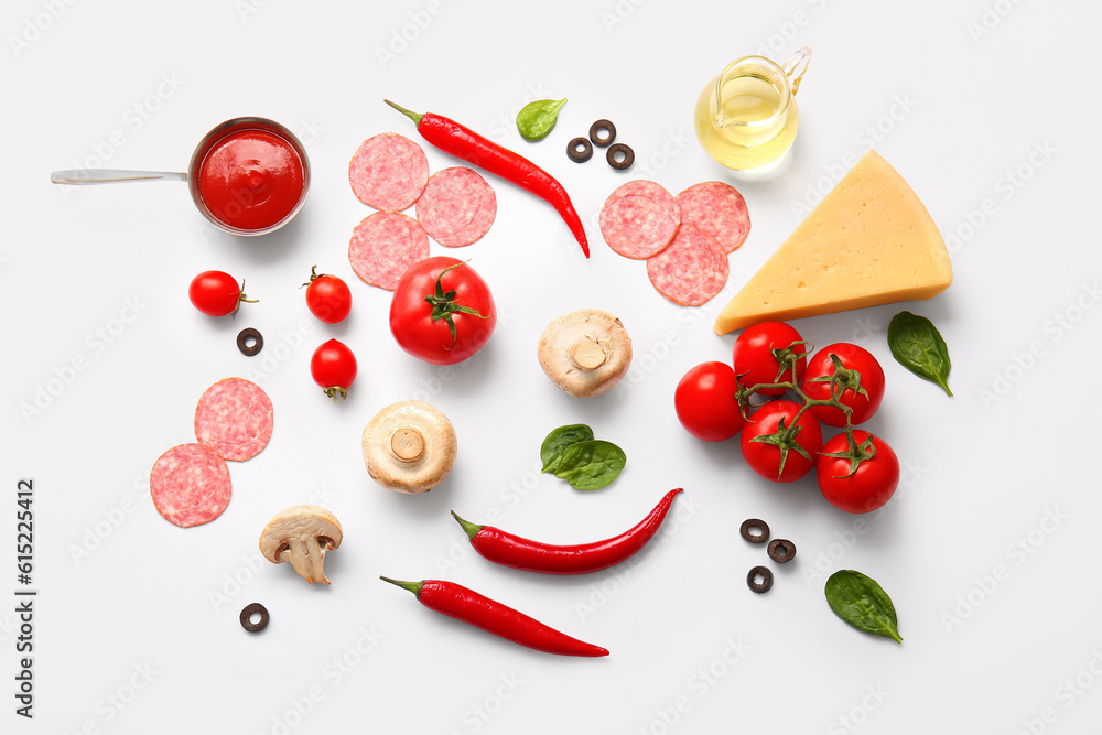 Fresh ingredients for preparing pizza on white background