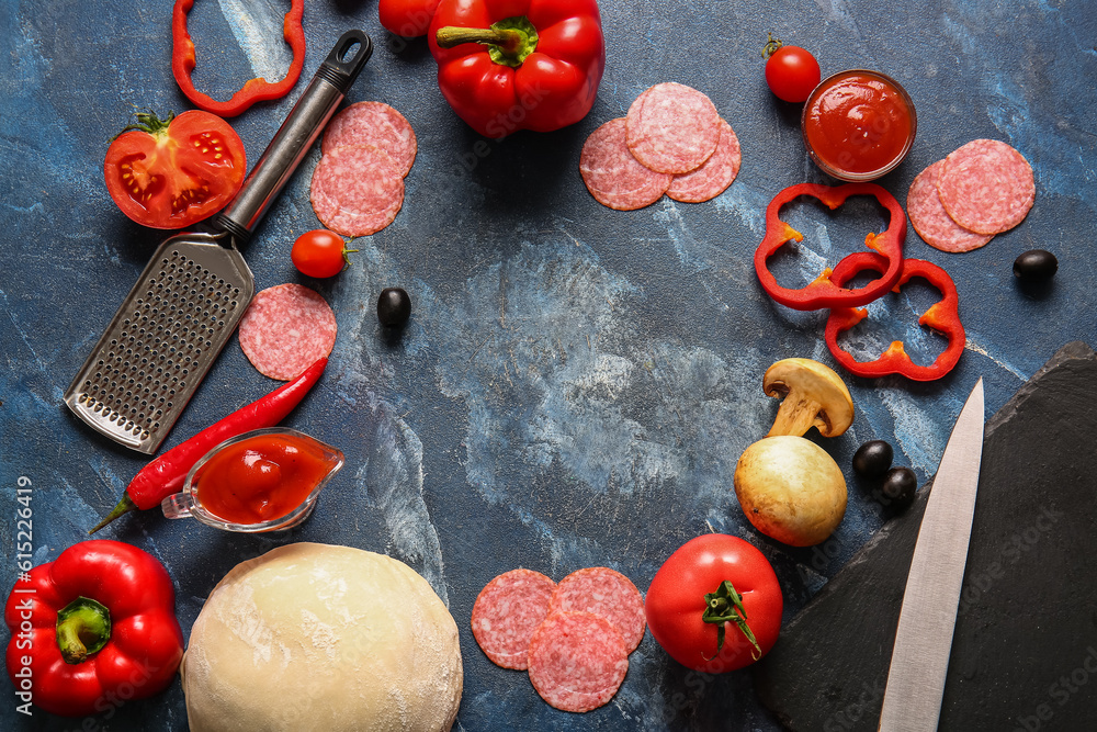 Frame made of fresh ingredients for preparing pizza on blue background