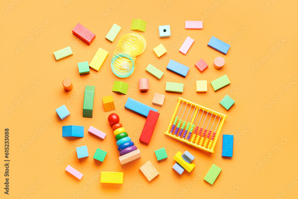 Different colorful toys on orange background. Childrens Day celebration