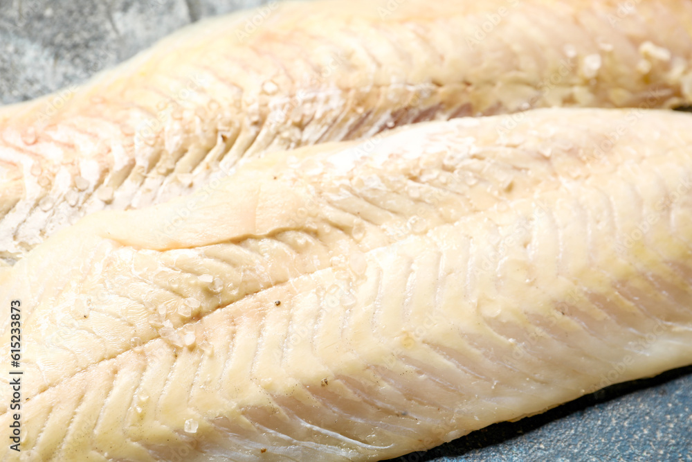 Raw codfish fillet on table, closeup