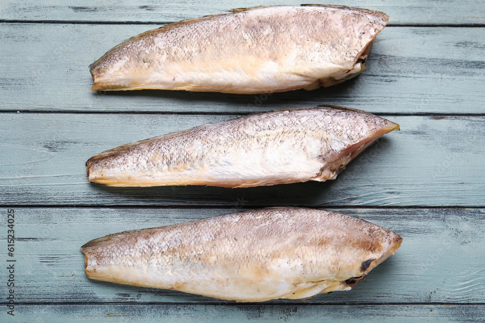 Raw codfish on green wooden background