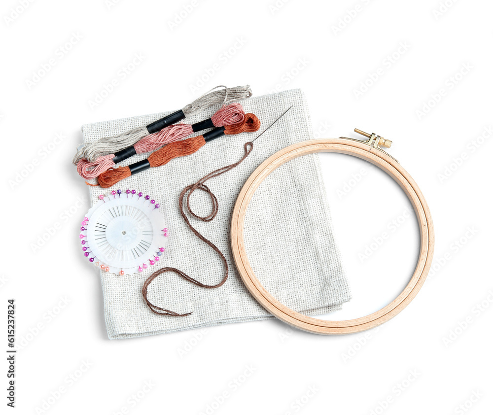 Wooden embroidery hoop with canvas, moulin threads and ball pins isolated on white background