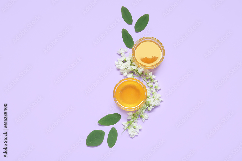 Composition with sweet honey and acacia flowers on purple background