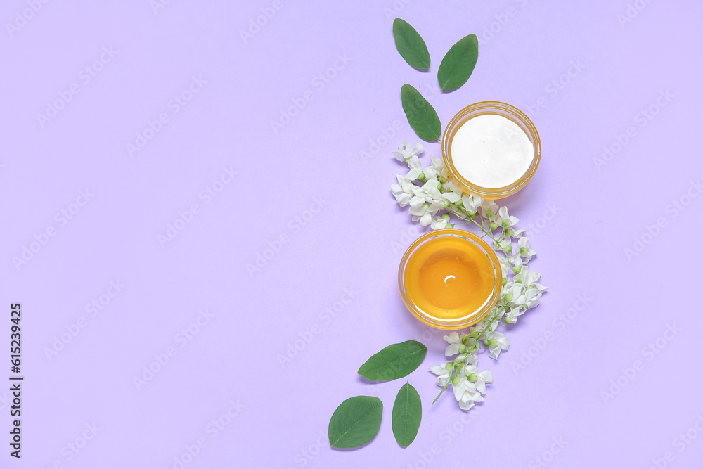 Composition with sweet honey and acacia flowers on purple background