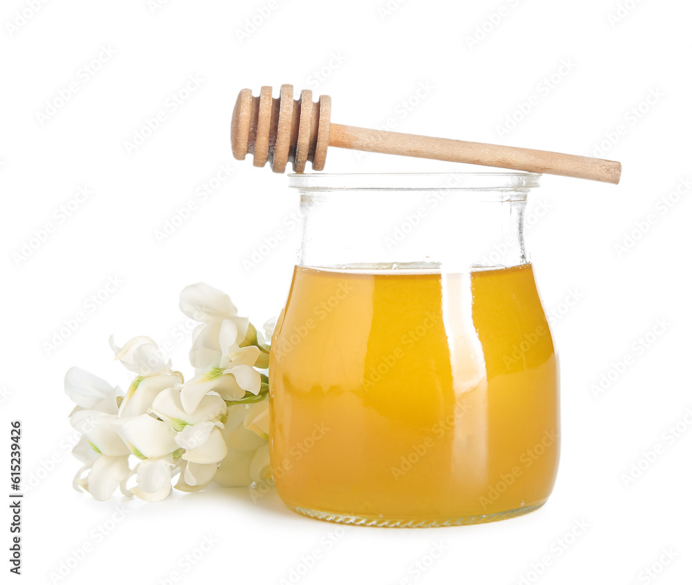 Jar of honey with flowers of acacia on white background