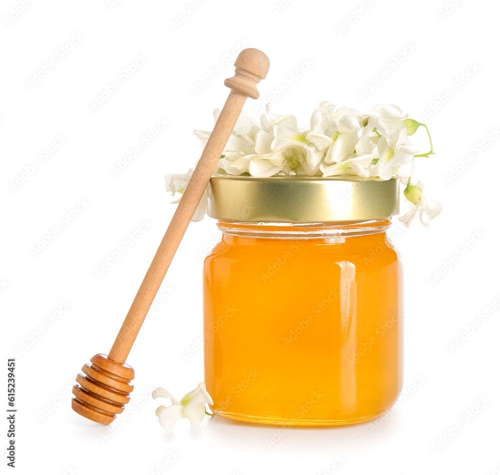 Jar of honey with flowers of acacia on white background