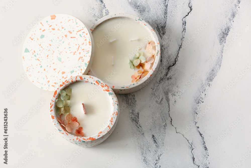 Holders with candles on white background