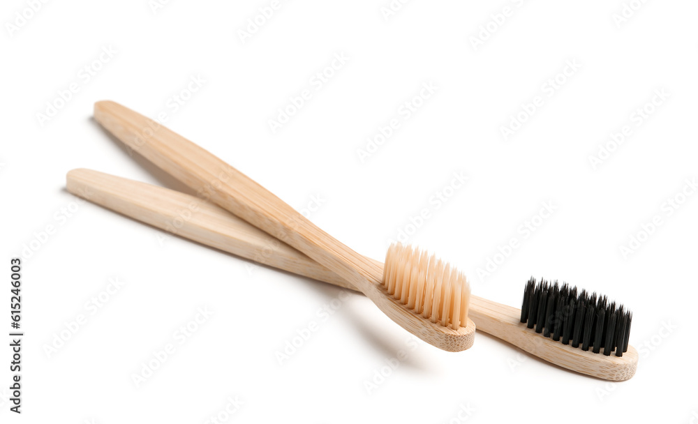 Different bamboo toothbrushes on white background