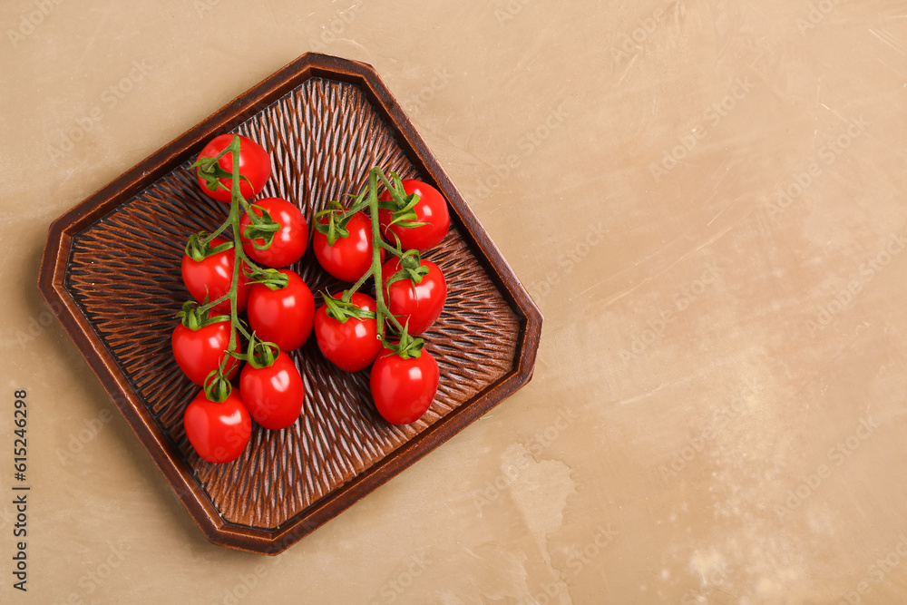 Tray with fresh cherry tomatoes on brown background