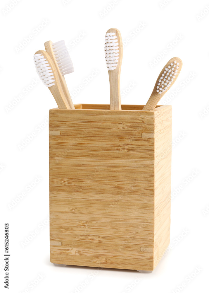 Bamboo tooth brushes in holder on white background