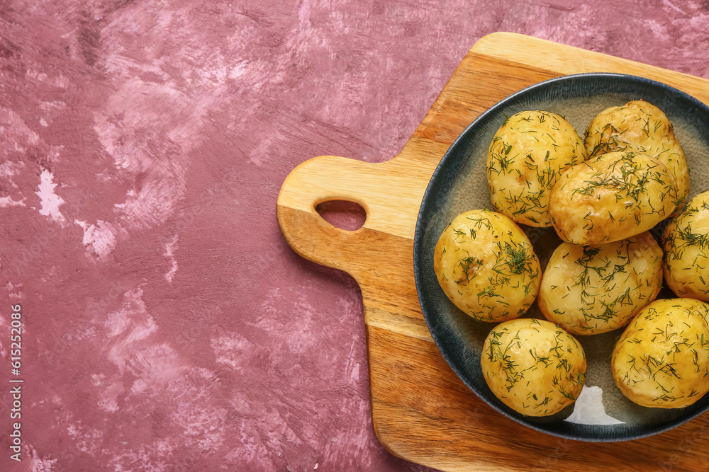 Plate of boiled baby potatoes with dill on purple background