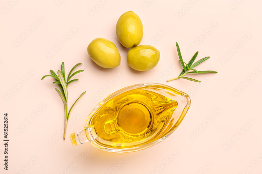 Gravy boat with fresh olive oil on pink background