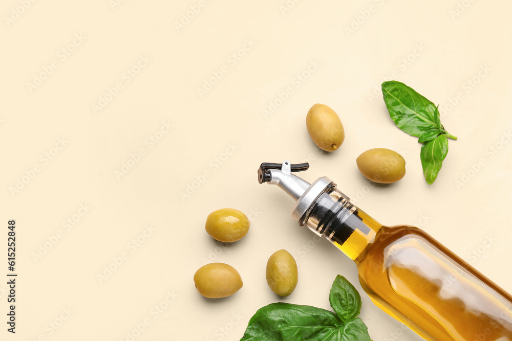 Bottle of fresh olive oil on beige background