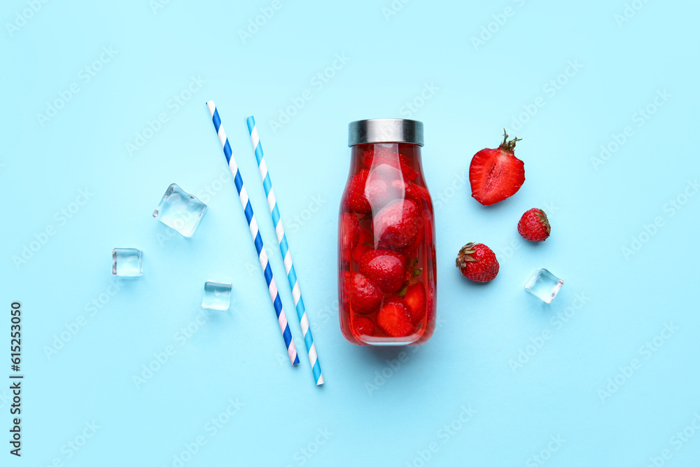 Sports bottle of infused water with strawberry on blue background