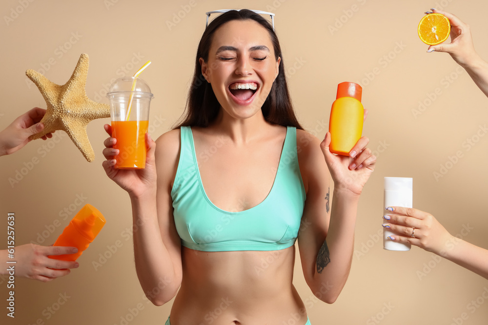 Young woman and female hands with sunscreen cream on beige background