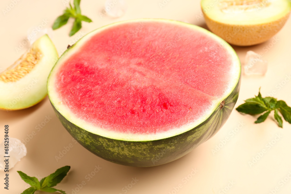 Half of fresh watermelon and melon on orange background