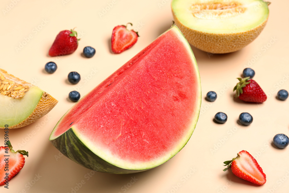 Piece of fresh watermelon and different berries on orange background