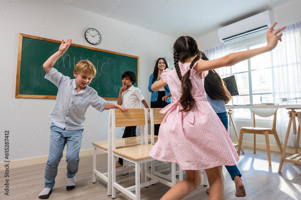 Group of student learn with teacher in classroom at elementary school. 