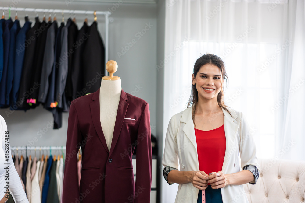 Portrait of Caucasian women fashion designer work in tailoring atelier. 