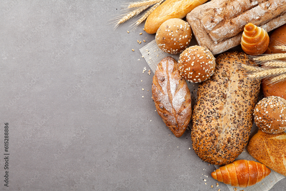 top view different kinds of fresh bread on the food slate.