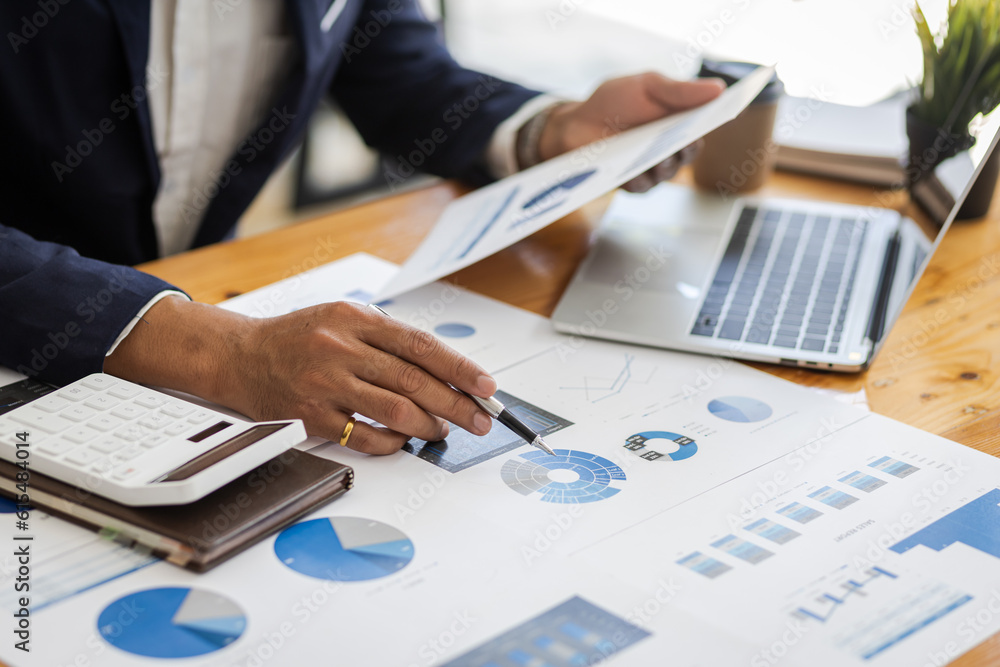 Businessman working on documents on the desk, data analysis of financial figures and business invest