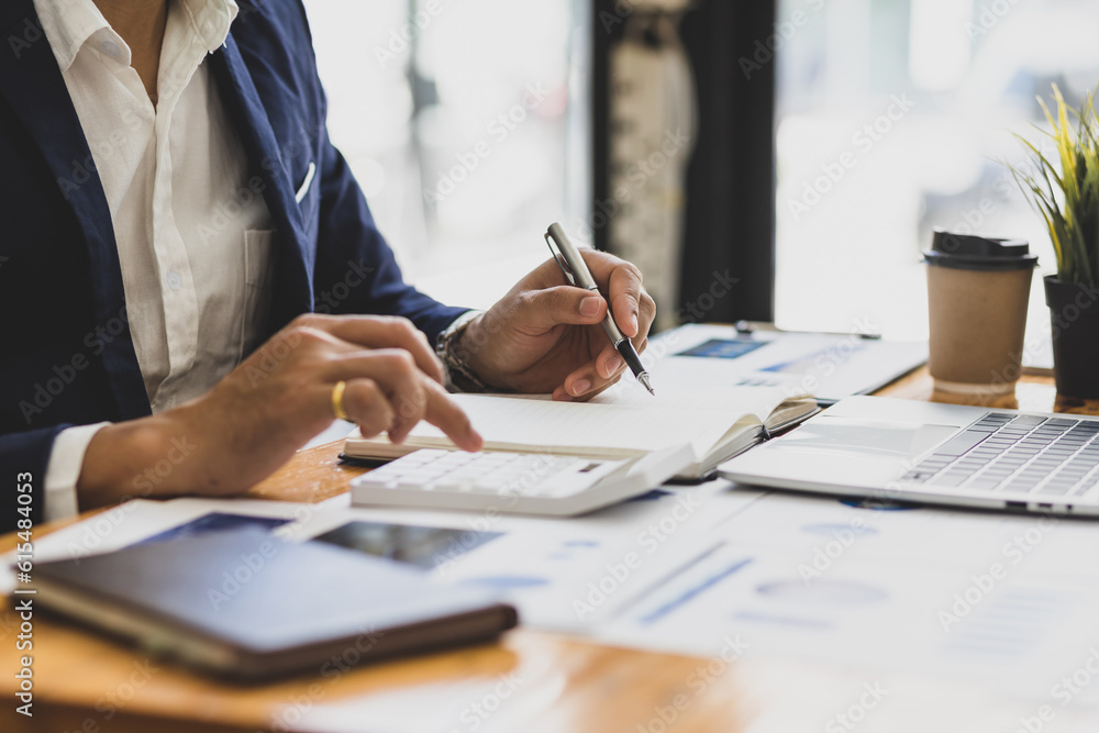 Businessman working on documents on the desk, data analysis of financial figures and business invest