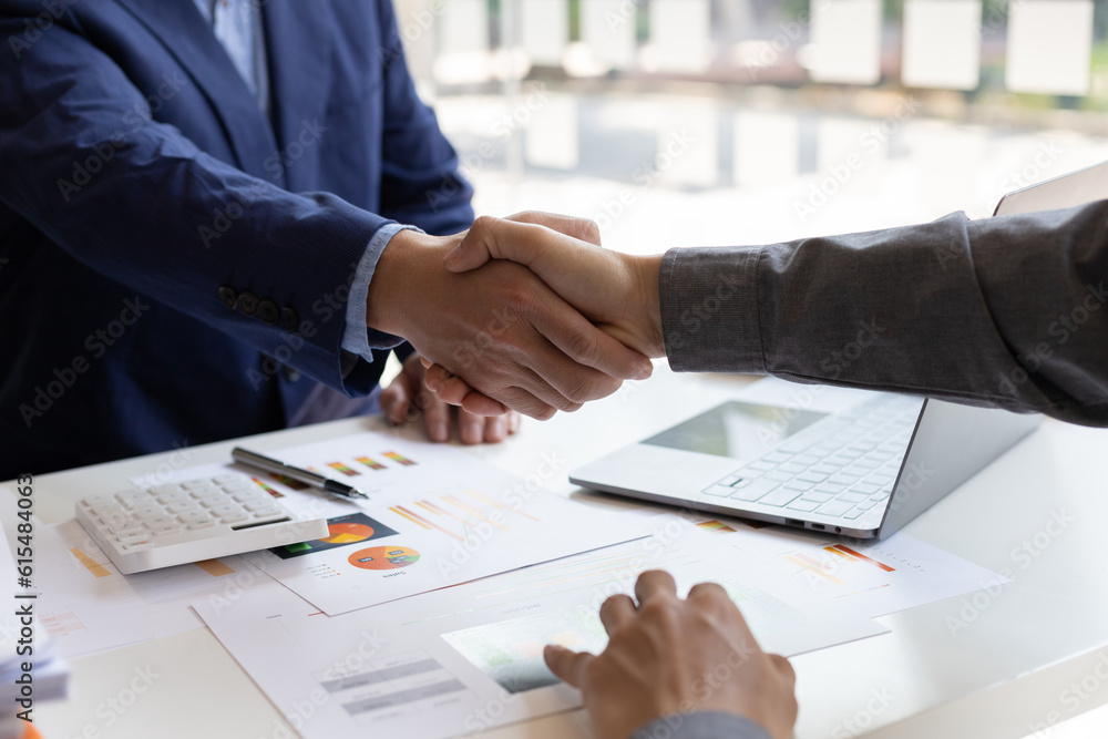 Business people shaking hands in a successful financial and investment cooperation meeting.