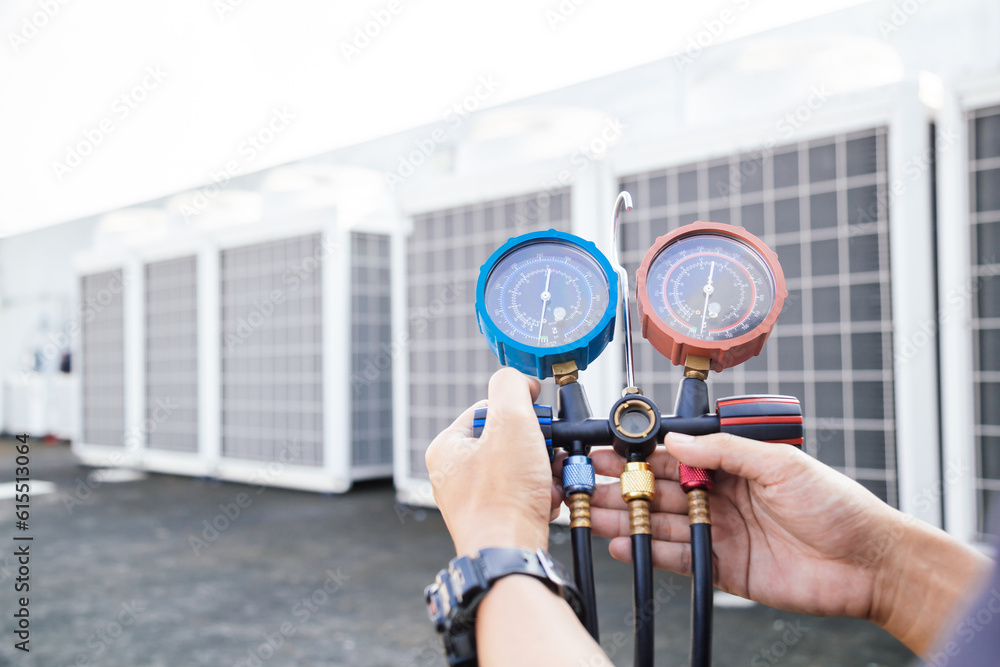 Technician is checking air conditioner ,measuring equipment for filling air conditioners.Cooling sys