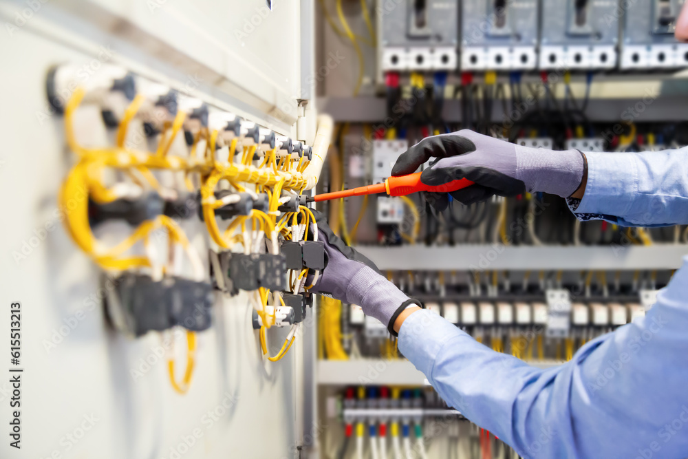 Electricians work to connect electric wires in the system, switchboard, electrical system in Control