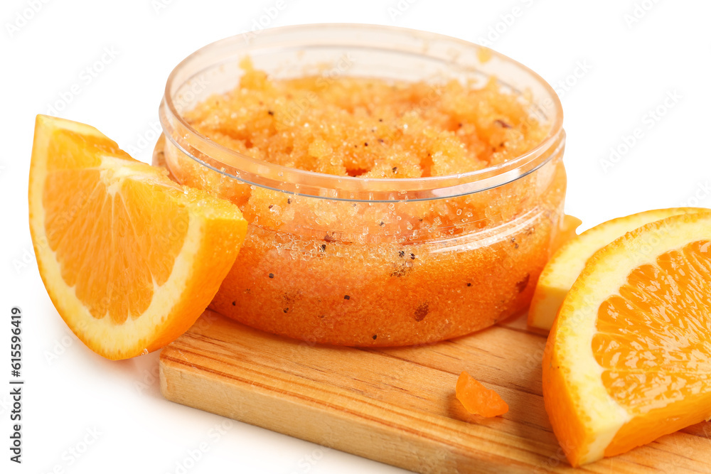 Wooden board with jar of natural body scrub and orange slices on light background, closeup